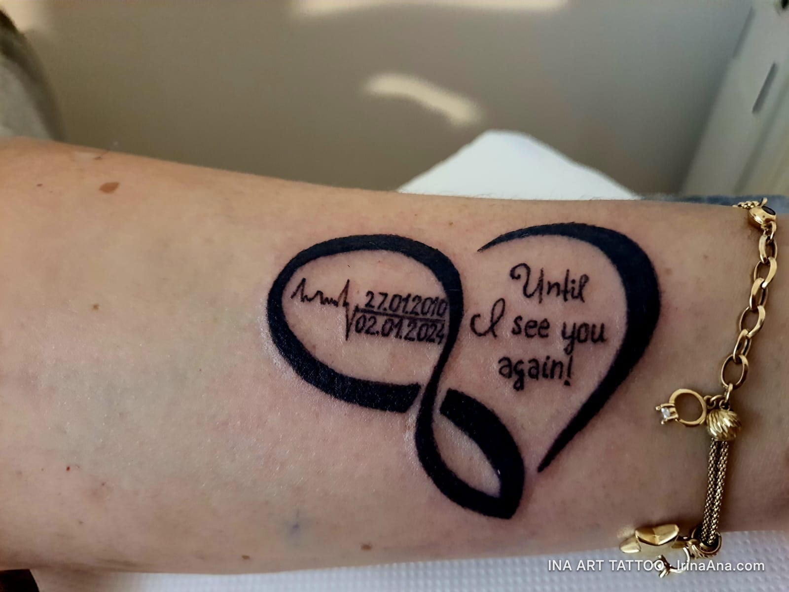 Forearm tattoo with an infinity symbol, a heart outline, dates, and the text Until I see you again!