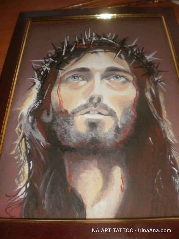 Oil painting of a bearded man with long hair, wearing a crown of thorns, with bloodstains on his face. Blue eyes gaze upward…