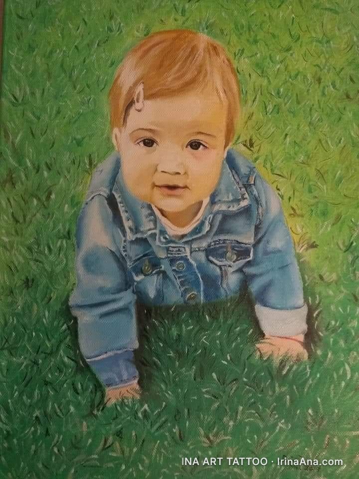 Oil painting of a red-haired baby wearing a denim jacket, poised to crawl on green grass.