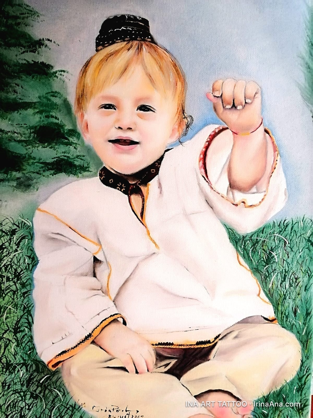 Painting of a smiling child with blond hair, wearing traditional Romanian clothes and a black cap, sitting on grass.