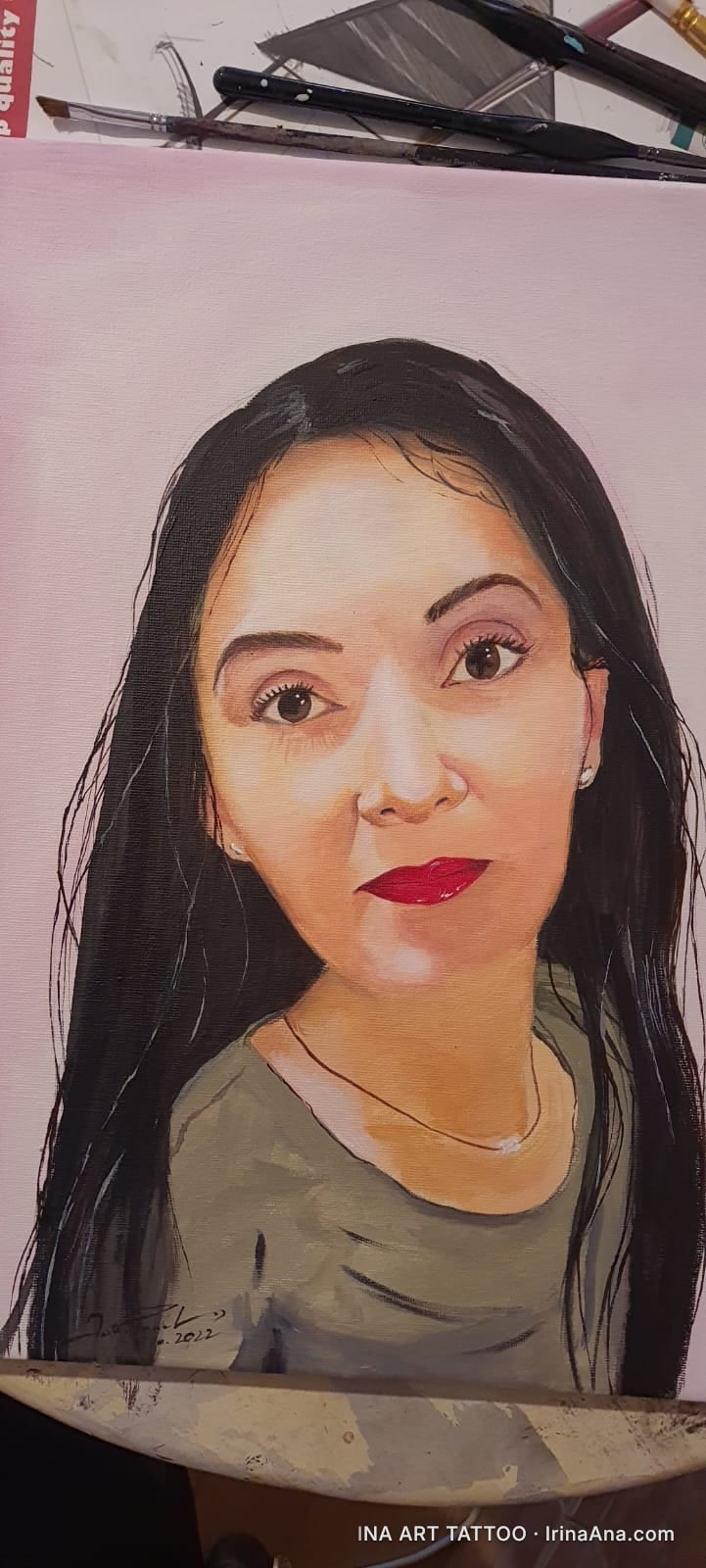 Painted portrait of a woman with long, black hair, red lips, and a green blouse, against a light pink background.
