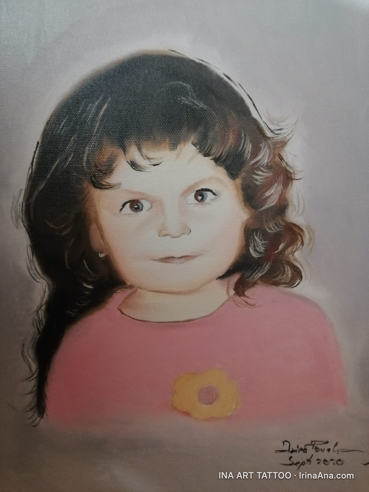 Oil painting portrait of a young girl with dark brown hair, brown eyes, wearing a pink shirt with a yellow flower.