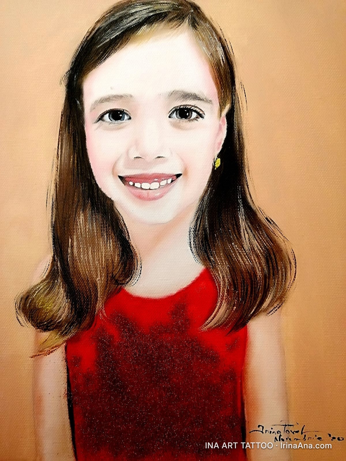 Portrait of a smiling young girl with brown hair and a red dress, against a beige background.
